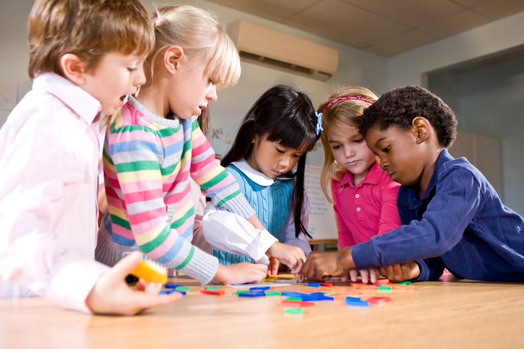 Preschool children working together on puzzle. Image shot 2009. Exact date unknown.